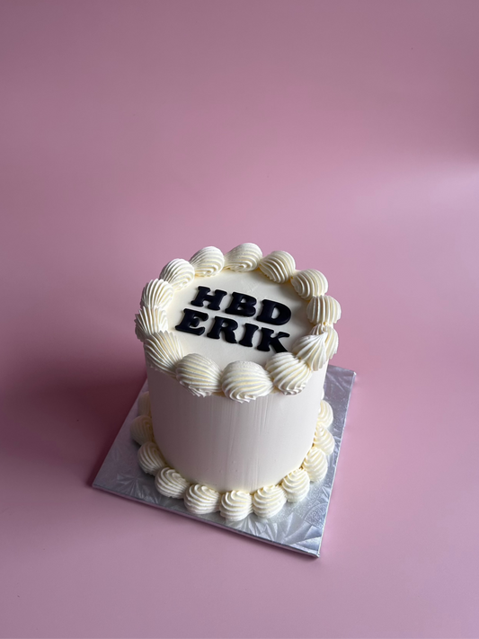 Classic minimalist 4-inch two-layer cake with smooth white frosting